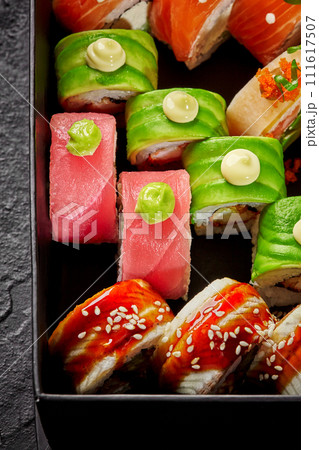Colorful set of various sushi rolls in cardboard box 111617507