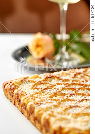 Lattice cheese galette with parmesan crumbs served in romantic setting Lattice cheese galette with parmesan crumbs served in romantic setting 111617584