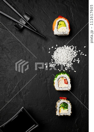 Artistic composition of sushi rolls with chopsticks and soy sauce Artistic composition of sushi rolls with chopsticks and soy sauce 111617605