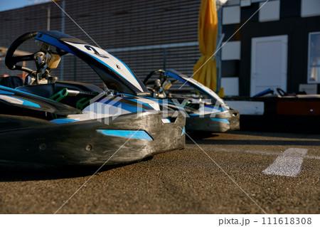 Go-cart sports car packed on outdoor track ready for recreational pursuit 111618308