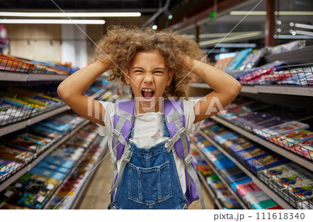 Stressed girl child feeling crazy during shopping at stationery shop Stressed girl child feeling crazy during shopping at stationery shop 111618340