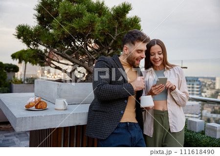 Business colleagues chitchatting during coffee break at office roof Business colleagues chitchatting during coffee break at office roof 111618490