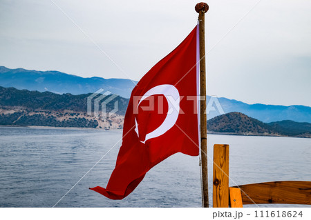 The flag of Turkey flutters in the wind on the deck of pleasure yacht. 111618624