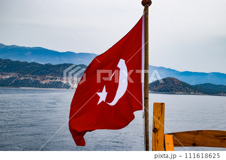 The flag of Turkey flutters in the wind on the deck of pleasure yacht. 111618625