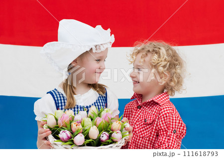 Dutch kids with tulip flowers and Netherlands flag 111618793