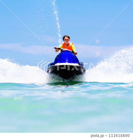 Teenager on jet ski. Teen age boy water skiing. 111618800