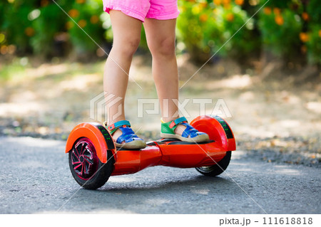 Child on hover board. Kids ride scooter. Child on hover board. Kids ride scooter. 111618818