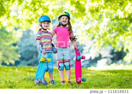 Children riding skateboard in summer park 111618831