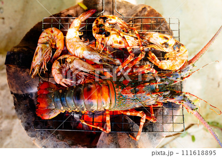 Seafood grill on the beach. Lobster and fish BBQ 111618895