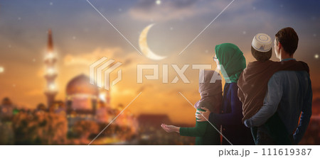 Ramadan Kareem greeting. Family looking at mosque. 111619387