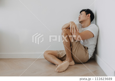 Lonely depressed man sit at the corner of the room. Lonely depressed man sit at the corner of the room. 111623689