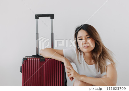 Bored and tired face woman in her private loungewear and baggage isolated on white. 111623709