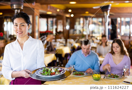 Portrait of positive waitress in restaurant Portrait of positive waitress in restaurant 111624227