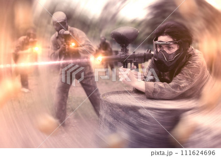 Portrait of asian female with gun on paintball field Portrait of asian female with gun on paintball field 111624696