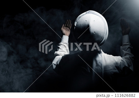 Muslim man raised her hands and prayed to Allah 111626882