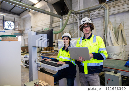 engineer team staff worker working in wooden furniture factory control operate wood cutter machine engineer team staff worker working in wooden furniture factory control operate wood cutter machine 111628340
