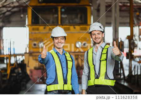 engineer male team staff worker happy smile work in locomotive depot train yard transportation heavy industry engineer male team staff worker happy smile work in locomotive depot train yard transportation heavy industry 111628358