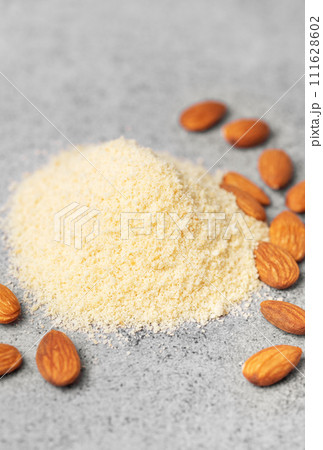 Fresh almond flour and almonds Fresh almond flour and almonds 111628602