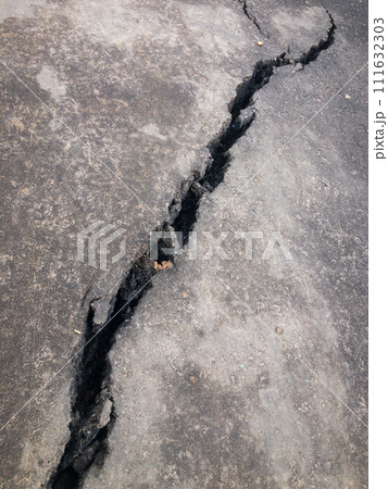Close-up of large crack in asphalt, concept of neglect and damage Close-up of large crack in asphalt, concept of neglect and damage 111632303