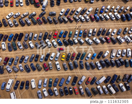Aerial view of crowded parking lot with various colored cars Aerial view of crowded parking lot with various colored cars 111632305