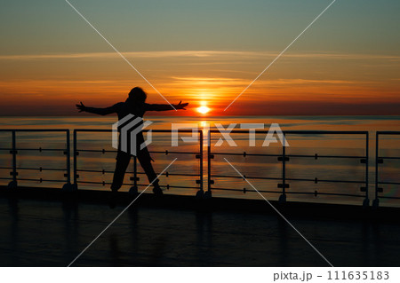 Girl silhouette in magical sunset over the Gulf of Finland, Baltic sea. 111635183