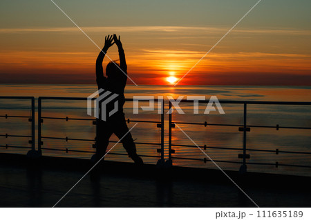 Girl silhouette in magical sunset over the Gulf of Finland, Baltic sea. 111635189