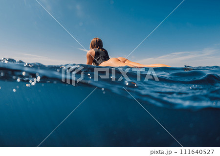 Beauty surfing girl in sexy bikini with surfboard. Water sport lifestyle on summer vacation 111640527