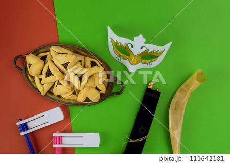 Symbolic Jewish festival of Purim with carnival masks hamantaschen cookies, Purim is known as greatest Jewish holiday of remembrance Symbolic Jewish festival of Purim with carnival masks hamantaschen cookies, Purim is known as greatest Jewish holiday of remembrance 111642181
