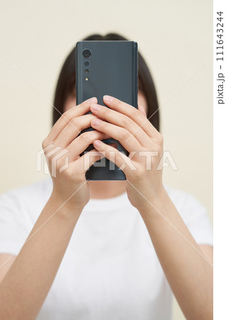 A woman sitting and taking pictures 111643244