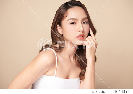 Beautiful young asian woman with clean fresh skin on beige background, Face care, Facial treatment, Cosmetology, beauty and spa, Asian women portrait. 111643355