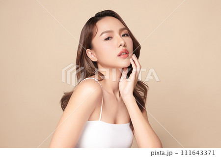 Beautiful young asian woman with clean fresh skin on beige background, Face care, Facial treatment, Cosmetology, beauty and spa, Asian women portrait. Beautiful young asian woman with clean fresh skin on beige background, Face care, Facial treatment, Cosmetology, beauty and spa, Asian women portrait. 111643371