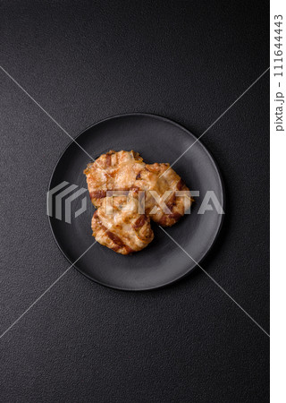 Round minced chicken or pork cutlet wrapped in bacon with salt, spices and herbs 111644443