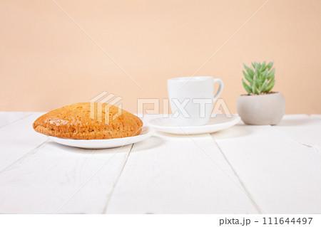 Minimalism, food on a background. Empty text space, mocap. Bun Tea Green beige white background. Ecological. 111644497
