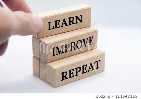 Learn, improve and repeat text on wooden blocks with white cover background. Improvement concept. Learn, improve and repeat text on wooden blocks with white cover background. Improvement concept. 111647318