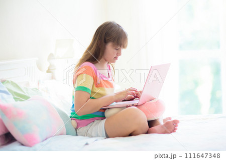 Teenager and computer. Girl chatting with friends. 111647348
