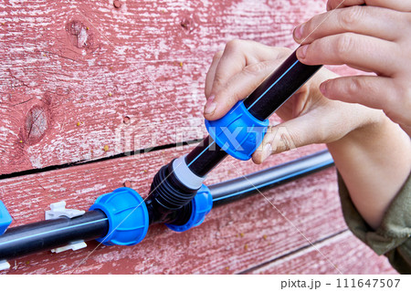 Installation of irrigation water supply with PVC pipe tee way compression clamp fitting. 111647507