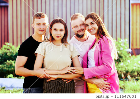 Smiling young European people in group portrait of two married c 111647601