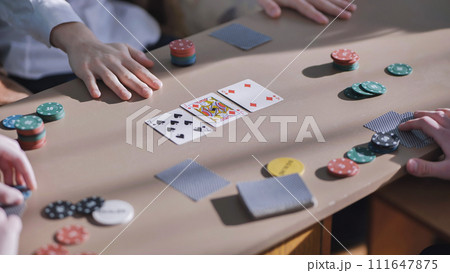 Young guys playing poker at a table. Young guys playing poker at a table. 111647875