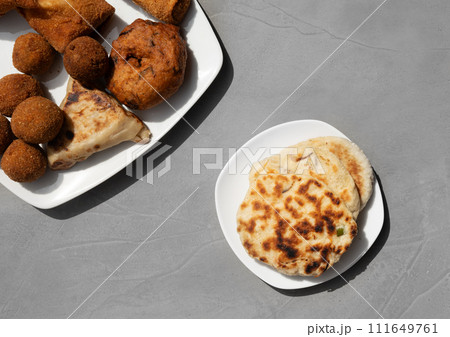 Authentic Sri Lankan different street food, short eats. Vegetable roti, Chinese Rolls , coconut roti, cutlets, mutton rolls on gray background. Snacks made with tuna, potatoes, onion and deep fried 111649761