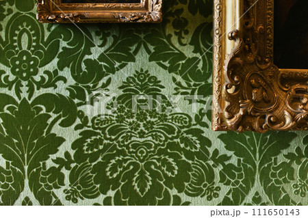 Green velvet wallpaper and gold frames with paintings 111650143