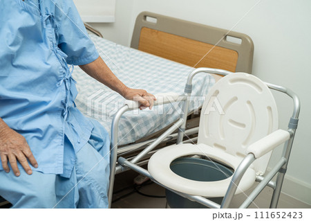 Flush toilet and shower chair in bathroom for old elder people. 111652423