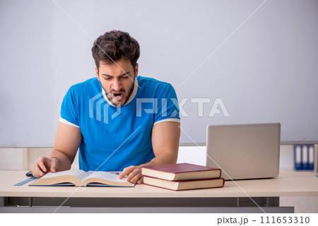 Young male student in front of whiteboard Young male student in front of whiteboard 111653310