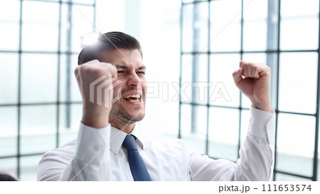 Male businessman in close-up in the office rejoicing 111653574