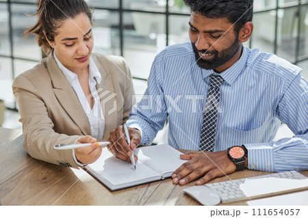Young account manager advisor lawyer showing paper documents to partner 111654057