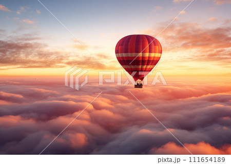 Colorful hot air balloon floats over a sea of clouds at sunset Colorful hot air balloon floats over a sea of clouds at sunset 111654189