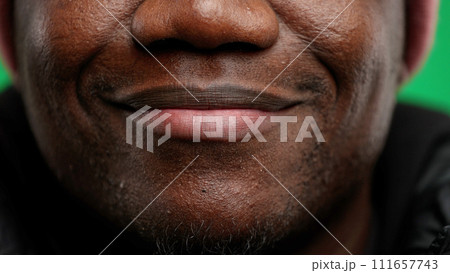 Man's mouth, close-up, on a green background 111657743