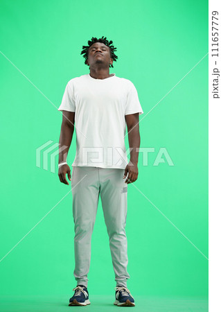 A man, full-length, on a green background, meditating A man, full-length, on a green background, meditating 111657779