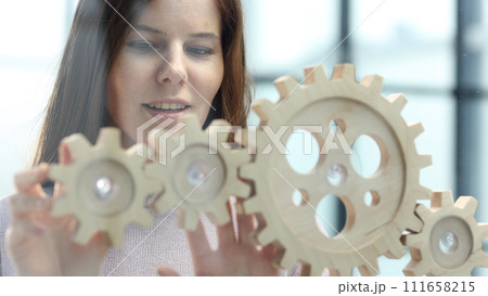 A woman in close-up in the office is thinking over a complex business plan A woman in close-up in the office is thinking over a complex business plan 111658215