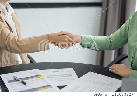 Alternative energy environment businesspeople shake hands after deal about renewable energy project 111658827