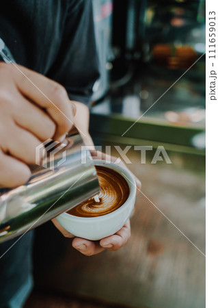 pouring milk for making latte art coffee 111659013